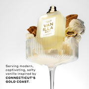 Vanilla Salt 50ml Eau De Parfum without cap in glass with vanilla ice cream, pieces of ice cream cone, and gold ring, on white background, above black text that reads "Serving modern, captivating, salty vanilla inspired by Connecticut's Gold Coast."