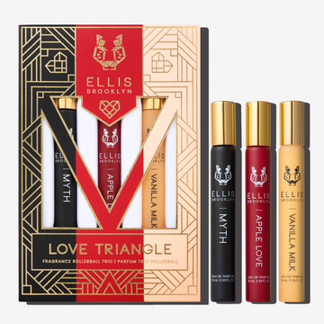 Black, red, beige and gold Love Triangle Fragrance Rollerball Trio Box showing Myth 10ml Fragrance Rollerball, Apple Love 10ml Fragrance Rollerball, and Vanilla Milk 10ml Fragrance Rollerball, on white background.