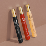 Myth 10ml Fragrance Rollerball, Apple Love 10ml Fragrance Rollerball, and Vanilla Milk 10ml Fragrance Rollerball, leaning on light brown background.